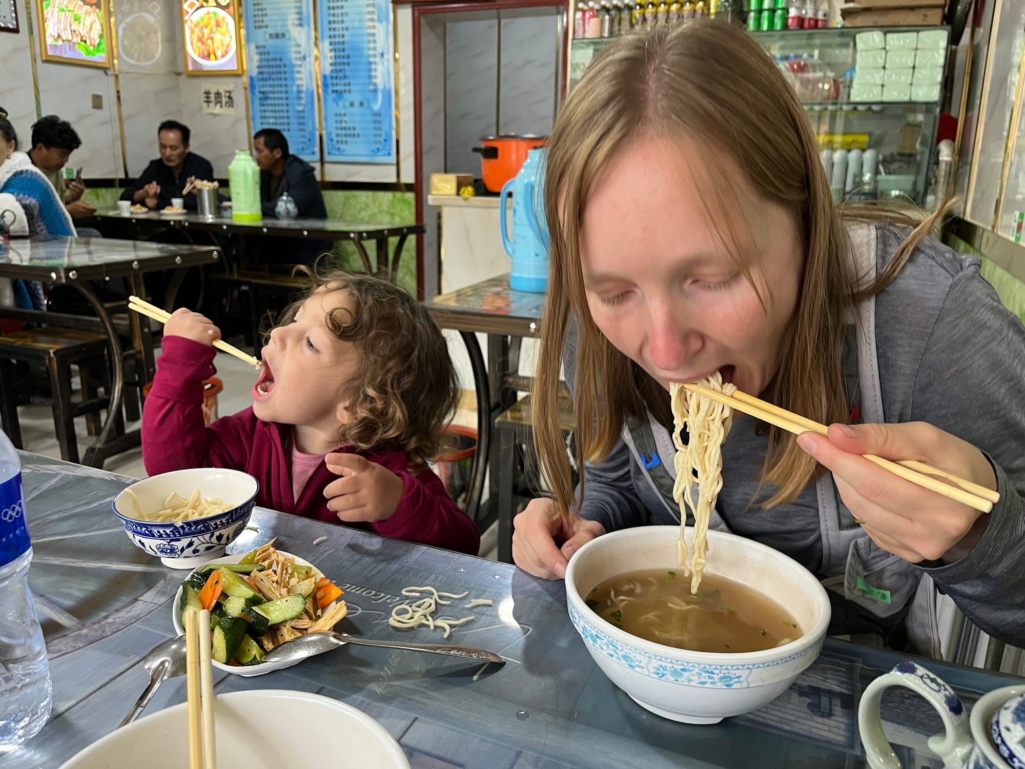 Toddler eating with chopsticks