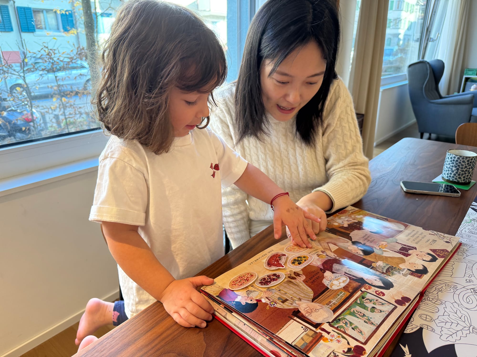 Showing a book to a Chinese friend