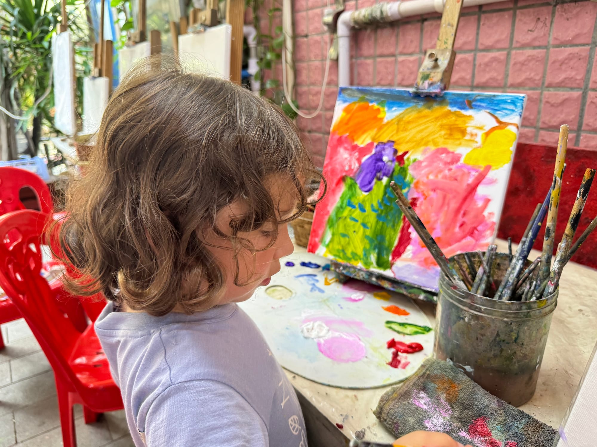 Hanna paining her own masterpiece at Dafen Oil Painting Village in Shenzhen